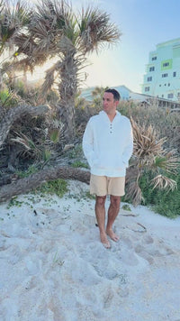 Video of Man wearing Indie Blue Knox Hoodie in White Muslin walking on the beach